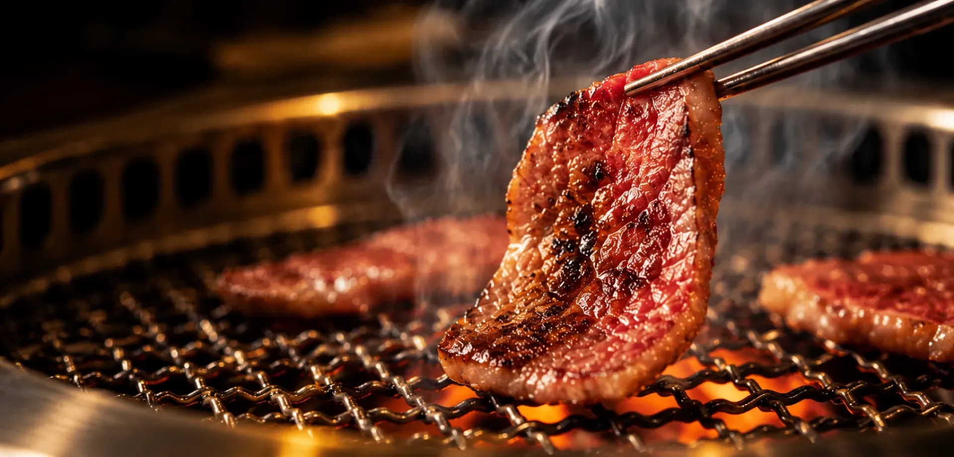 A Yakiniku King chef preparing a grilled dish
